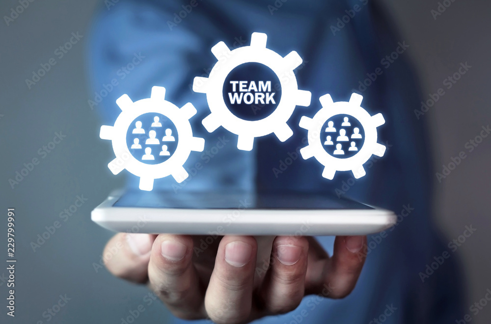 Man holding tablet with gear mechanism. Teamwork concept Man holding tablet with gear mechanism. Teamwork concept