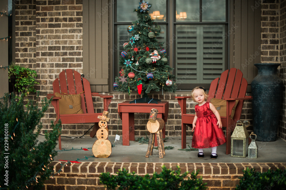 © Samantha McBride - Girl in a red dress standing on a patio © Samantha McBride - Girl in a red dress standing on a patio