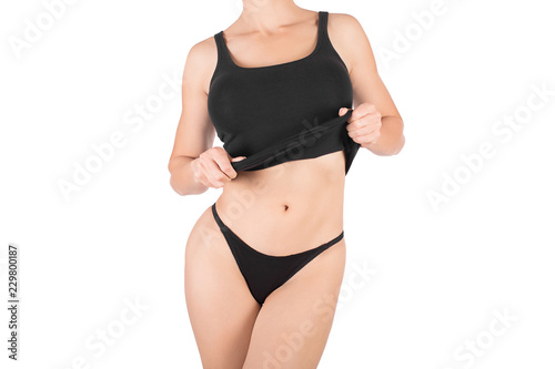 Female cropped fit body in black tank top and panties, isolated on white.