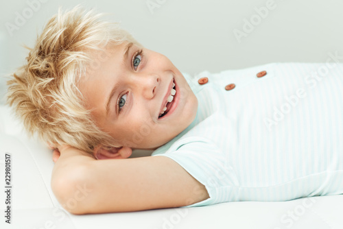 Smiling boy lying down