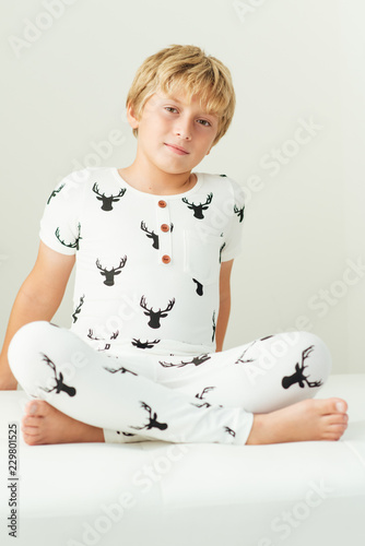 Young boy sitting with his legs crossed