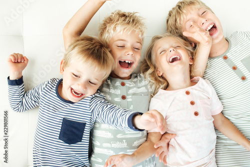 Siblings lying down and playing