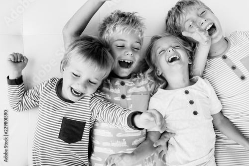 Siblings lying down and playing