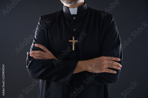 Obraz na plátně Crossed arms priest portrait senior