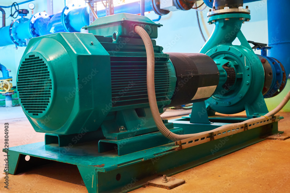 Blue engine with a pump standing on a metal stand. Blue engine with a pump standing on a metal stand.