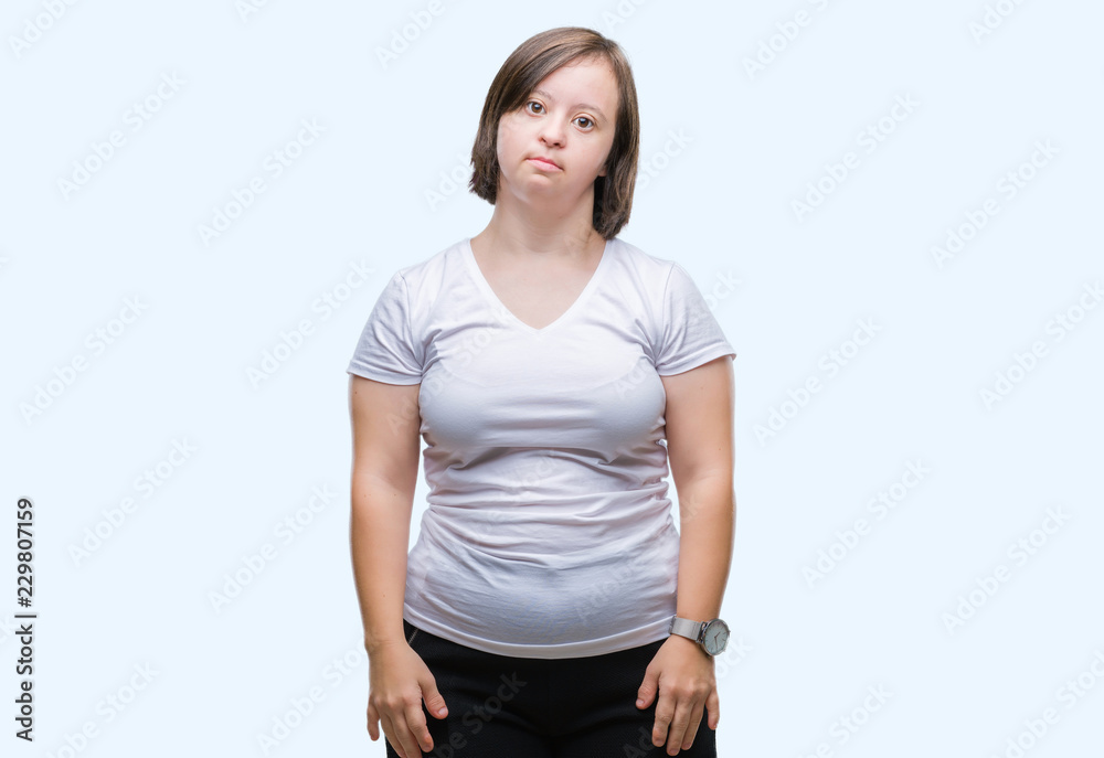 Young adult woman with down syndrome over isolated background with serious expression on face. Simple and natural looking at the camera. Young adult woman with down syndrome over isolated background with serious expression on face. Simple and natural looking at the camera.