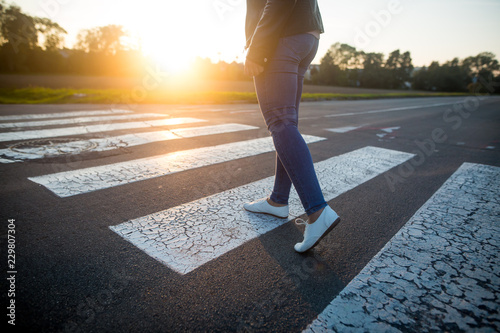 woman crossing the road at pedestrian crossing
