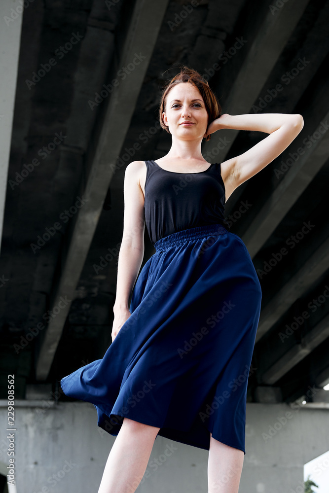 young girl posing under the bridge, dressed in black, modern architecture young girl posing under the bridge, dressed in black, modern architecture