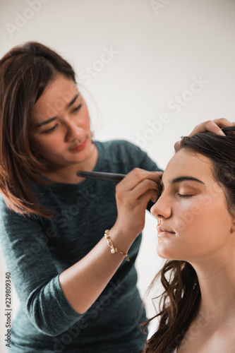 woman having make up applying by artist 