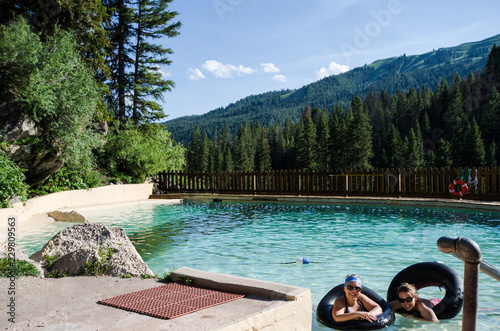Obraz na plátně Two female friends enjoy Granite Creek Hot Springs in Jackson Wyoming with black