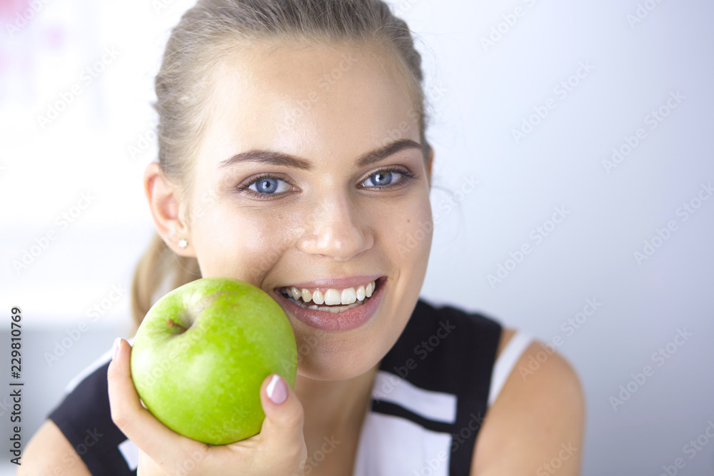 Young beautiful smiling girl with a green apple in hands Young beautiful smiling girl with a green apple in hands