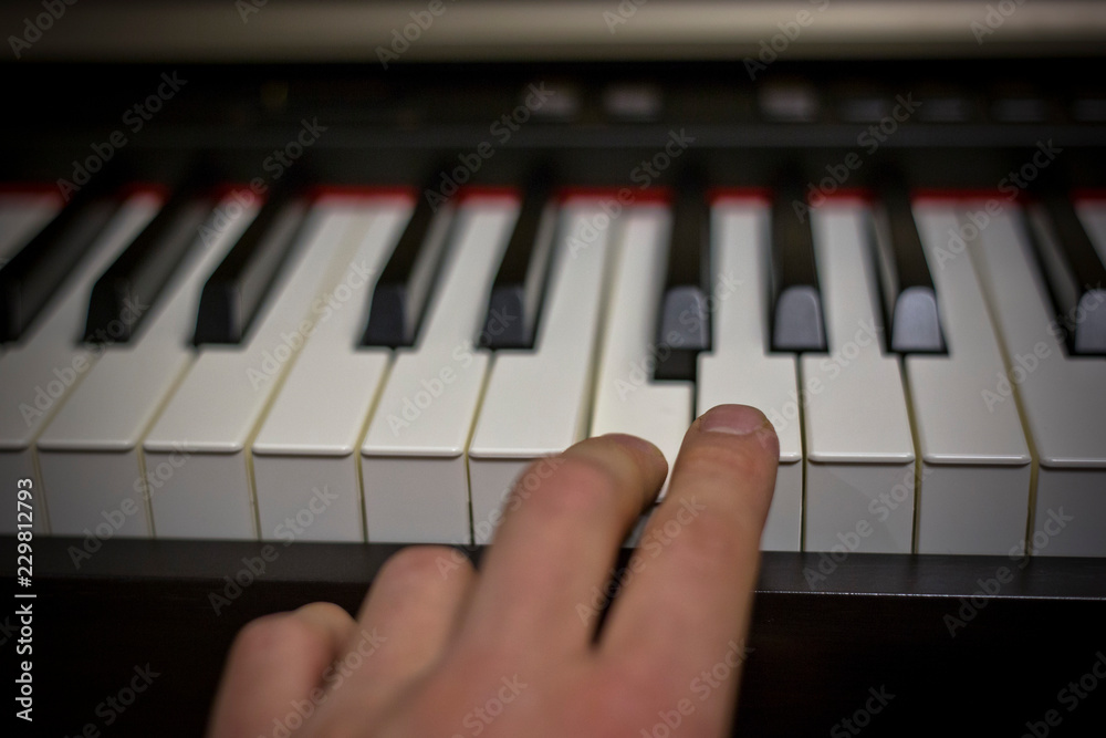 Fototapeta premium Playing on classic electrical piano keyboard