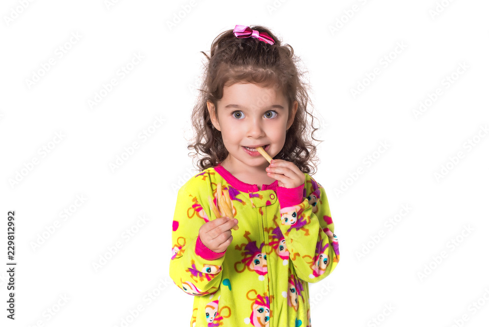 Pretty little girl eating french fries, isolated on white background. Pretty little girl eating french fries, isolated on white background.