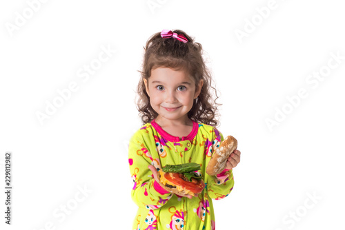 Pretty little girl eating a sandwich isolated on white background
