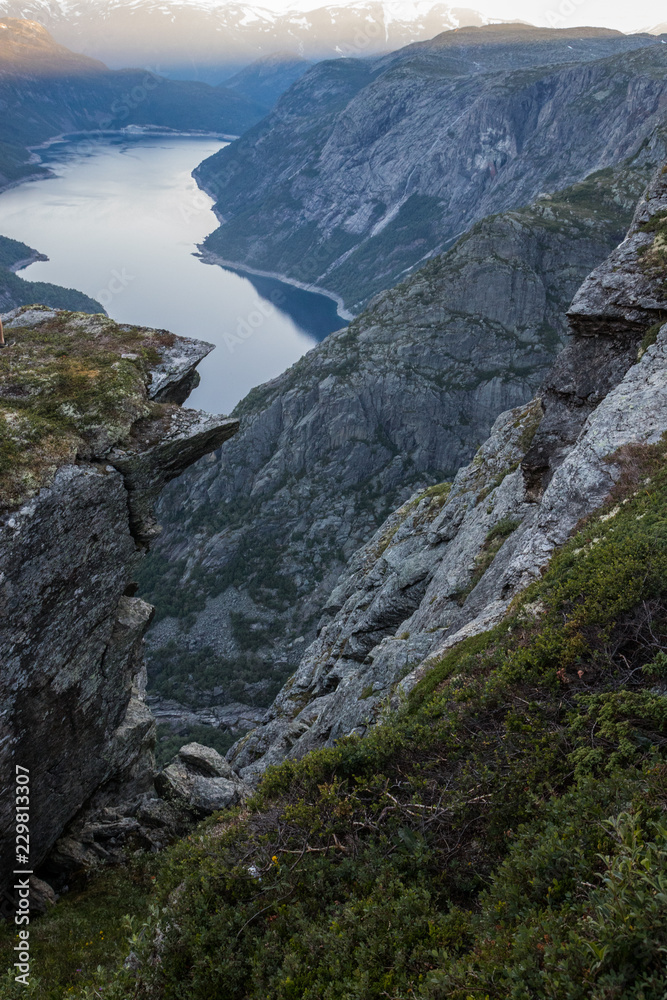 Obraz premium view of fjord through mountain ridge norway