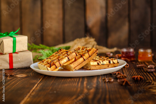 fresh belgian Tasty waffles and gifts on a wooden background. top view. photo