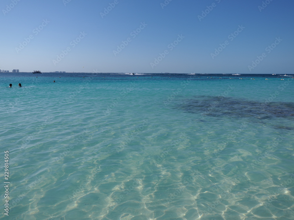Marvelous view of turquoise waters of Caribbean Sea landscape with horizon line at Cancun city in Mexico Marvelous view of turquoise waters of Caribbean Sea landscape with horizon line at Cancun city in Mexico