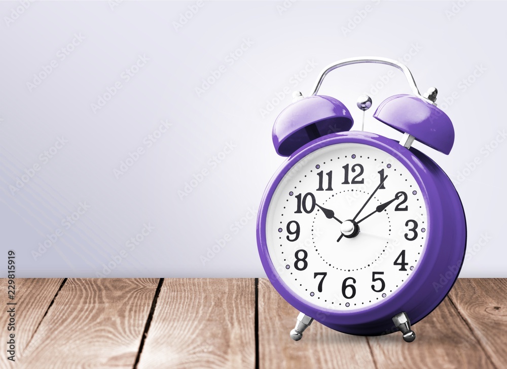 Retro alarm clock on table background Retro alarm clock on table background