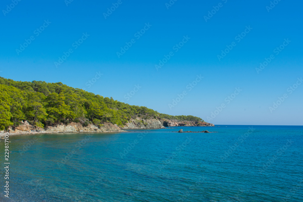 Beautiful landscape, mountains and sea against blue sky. Phaselis Beach in Antalia Turkey 