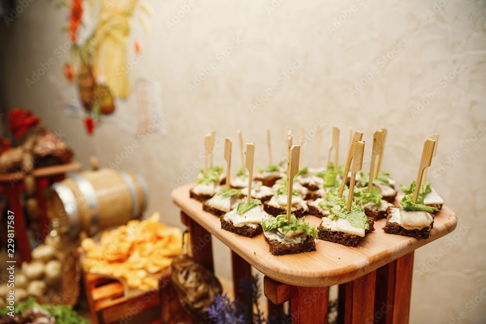 Catering banquet table with different food snacks and appetizers
