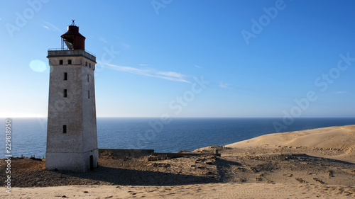 lighthouse on the beach © Maria