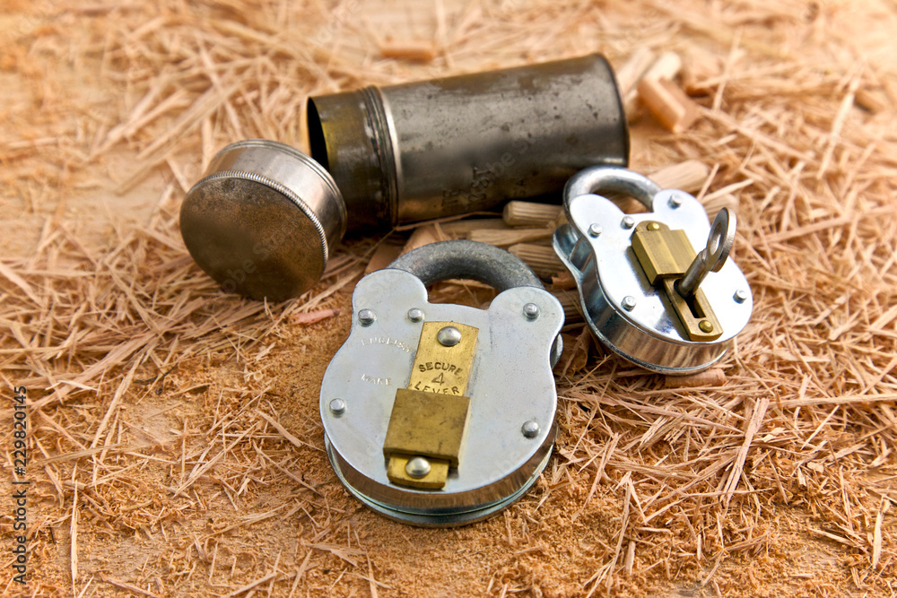 Two Metal Locks on top of Wooden Shavings