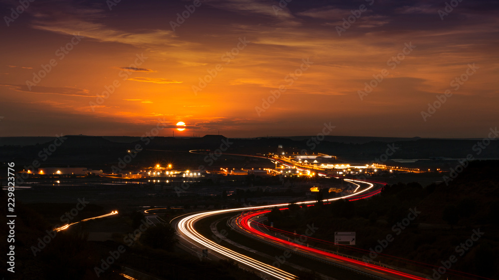 Sun on the Horizon and Road and Traffic in the Dark