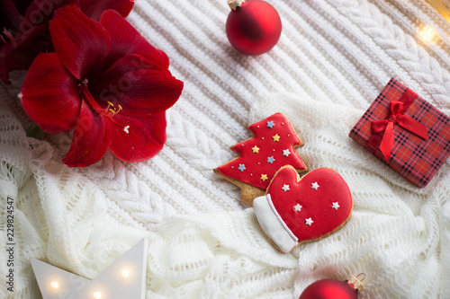 Christmas gingerbread on white knitted plaid surrounded with winter decor.