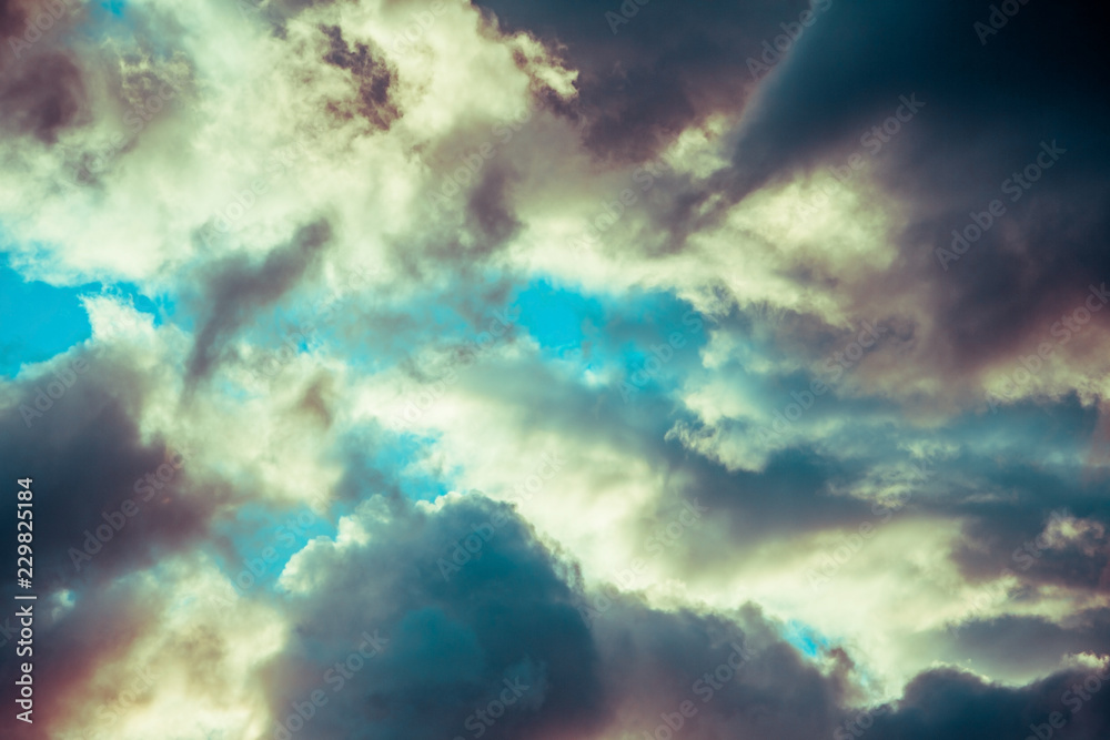 dark clouds on a blue sky at sunset or sunrise.