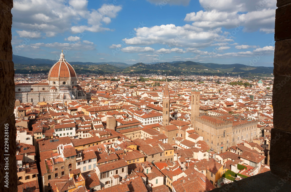 Churches under cloudscape and historical center with narrow streets, ancient Tuscany houses in Florence, Italy. UNESCO World Heritage Site