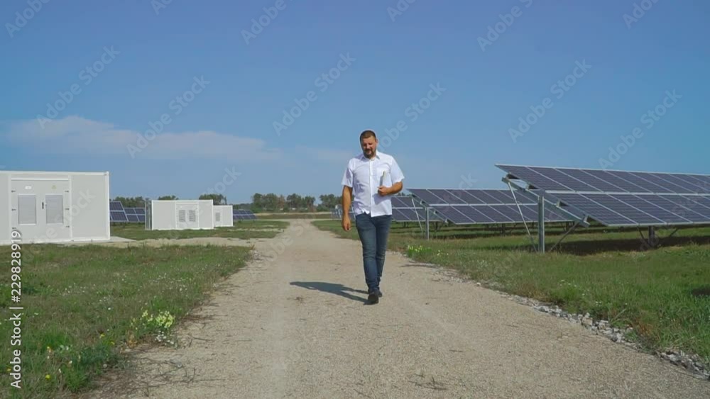 Businessman inspects solar panels. Businessman inspects solar panels.