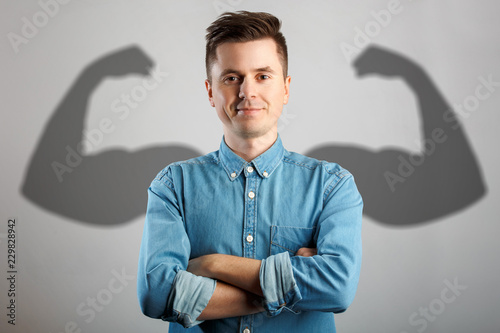 Man has shadow with strong arms photo