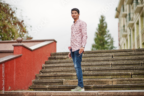 Indian man student at shirt posed outdoor.