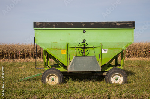 grain wagon sitting at edge of corn field