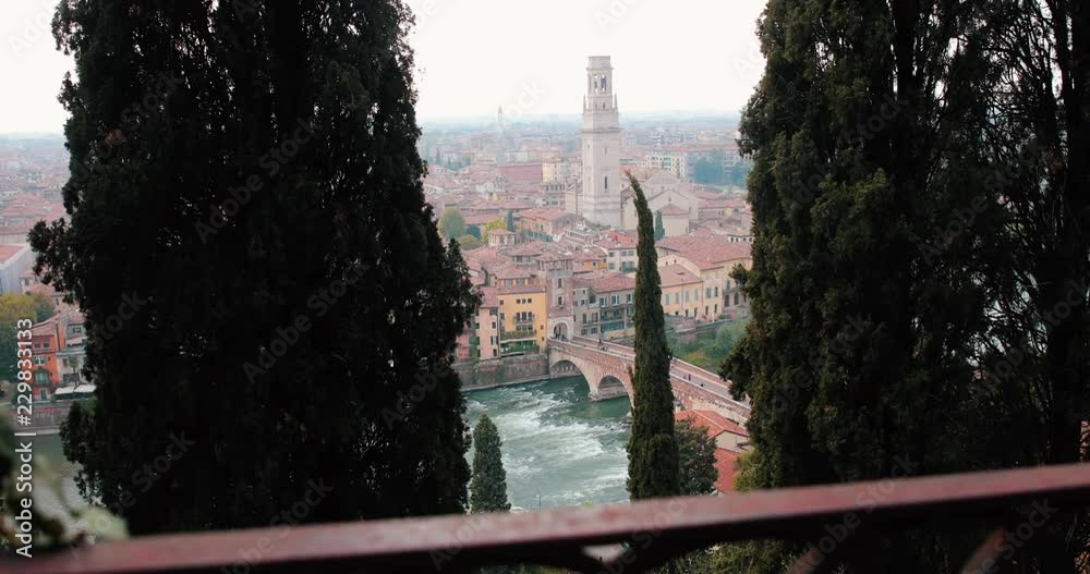 Slow motion shot of the landscape of Verona, Italy, as seen from the touristic point of view of Castel San Pietro. Smooth forward camera pan.