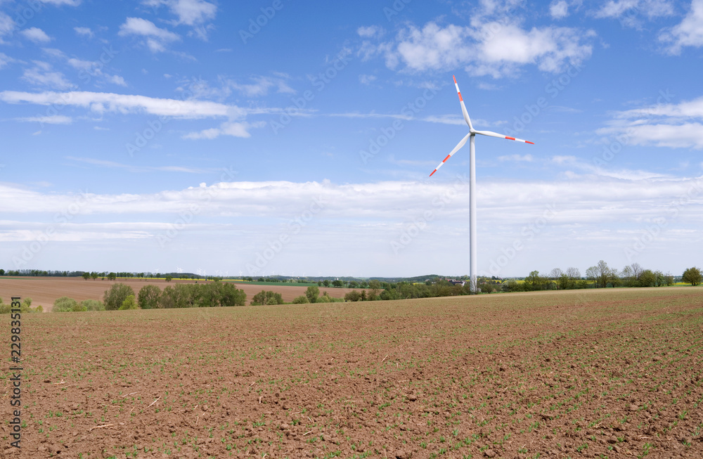 Wind Energy: Modern three bladed wind turbine in the rural East Thuringian landscape on a beautiful day in April Wind Energy: Modern three bladed wind turbine in the rural East Thuringian landscape on a beautiful day in April