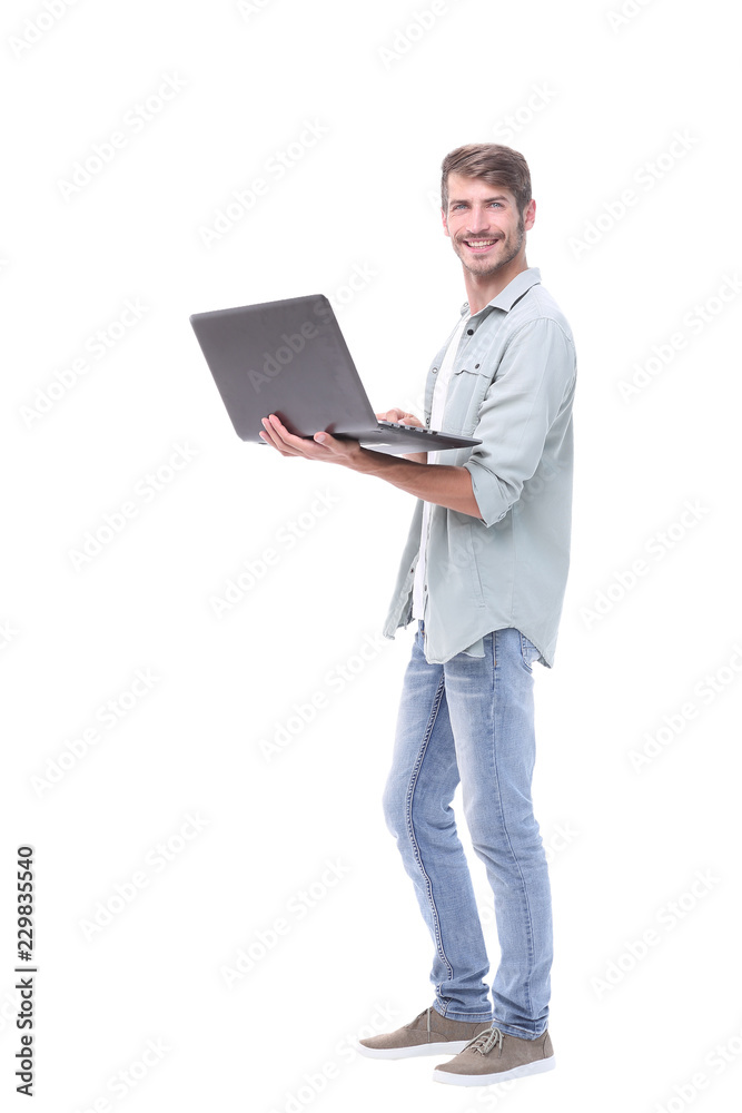 in full growth.successful young man with a laptop in full growth.successful young man with a laptop