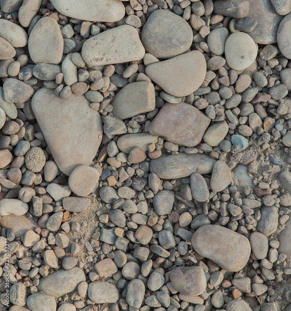 Gray stones of different sizes, stone background, stones on the beach Gray stones of different sizes, stone background, stones on the beach