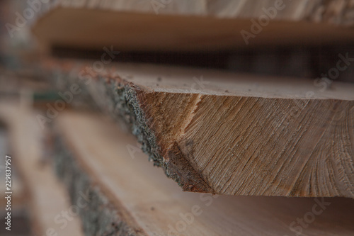 Folded wooden planks in a sawmill. Piled boards as texture © volody10