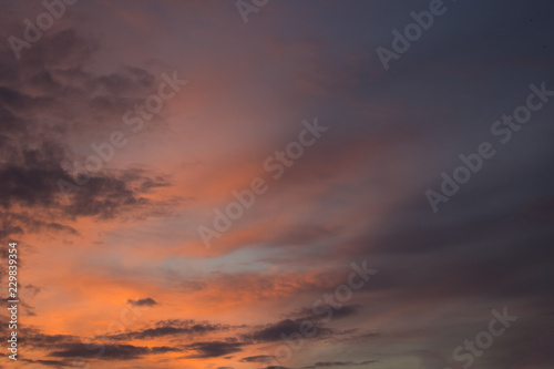 evening orange and pink soft colors fuzzy sky with clouds background wallpaper concept, copy space