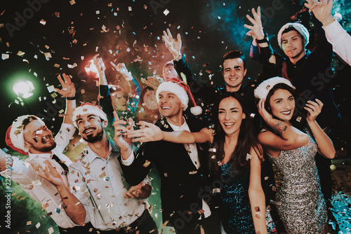 People in Santa Claus Cap Celebrating New Year.