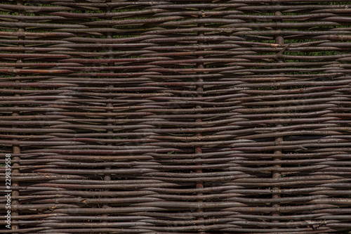 Wooden brown texture of thin rural fence rods