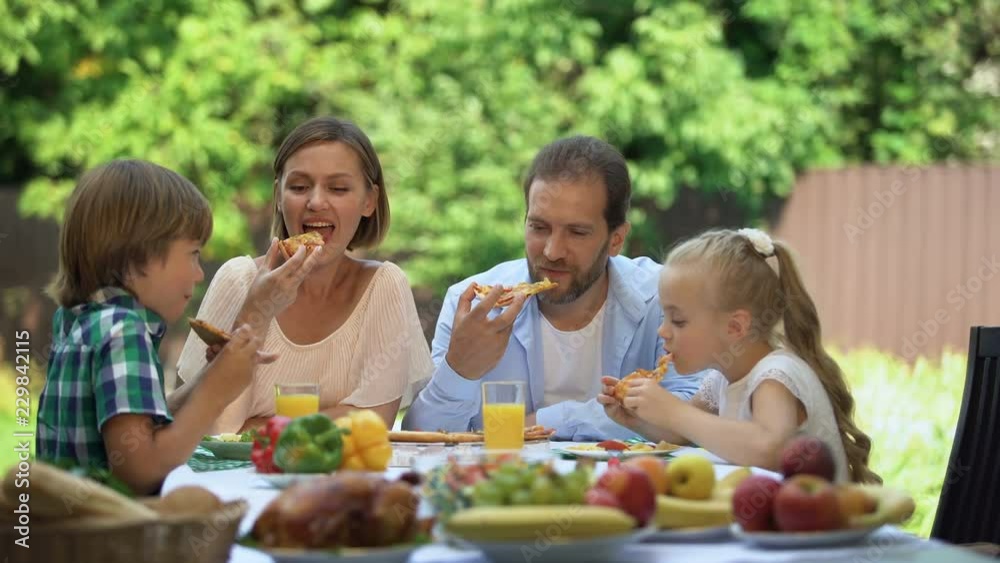 Enjoying taste fresh baked pizza, family dining together, food delivery service Enjoying taste fresh baked pizza, family dining together, food delivery service