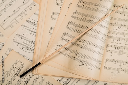 Wand On Music Notes Sheets And Music Book Background photo