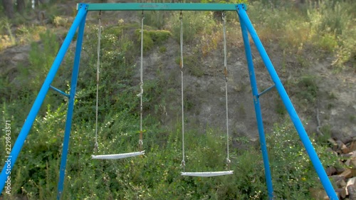 Abandoned swing in a wild camp photo