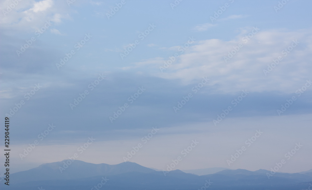 vivid mountain silhouette horizon line scenery nature landscape in evening twilight time and soft blue fog everywhere, copy space wallpaper