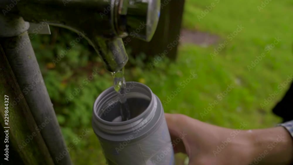 Guy filling up a water bottle with water. Slowmotion. Guy filling up a water bottle with water. Slowmotion.