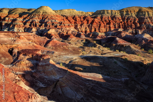 Rainbow City  Wucai Cheng. Colorful Red  Pink  Orange and Yellow landforms in the desert area of Fuyun County - Altay Perfecture  Xinjiang Province Uygur Autonomous Region  China. Rainbow Mountains