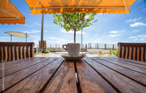 Portuguese espresso coffe cup or bica over wooden table photo