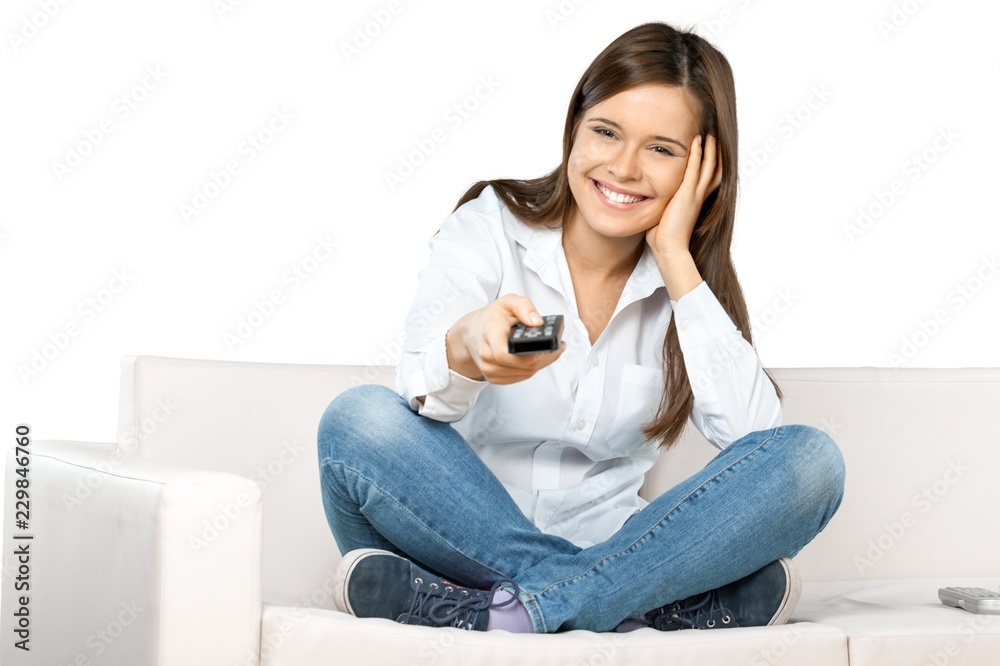 Obraz premium Smiling Woman Using Remote Control